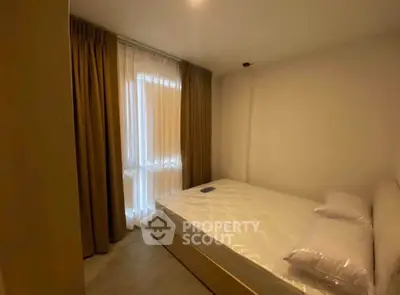 Cozy bedroom with natural light and elegant curtains, perfect for restful nights.