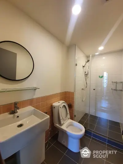 Modern bathroom with sleek fixtures and glass shower enclosure