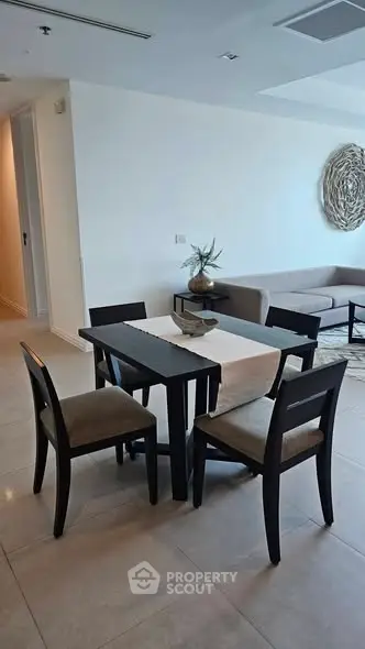 Modern dining area with elegant table and chairs in a stylish living room setting.