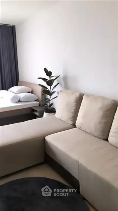 Modern living room with beige sofa and stylish decor in a contemporary apartment.