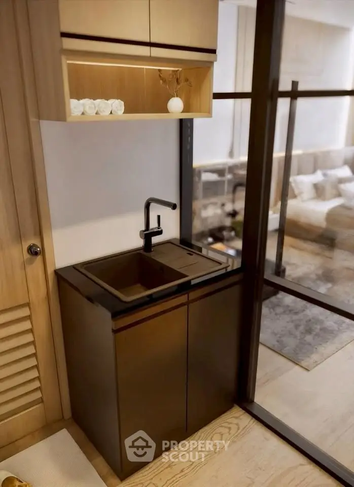 Modern compact kitchen with sleek black sink and wooden cabinetry