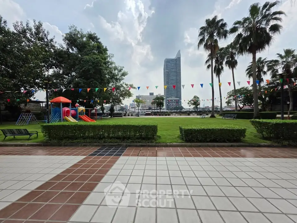 Spacious garden with playground and cityscape view, ideal for family living.