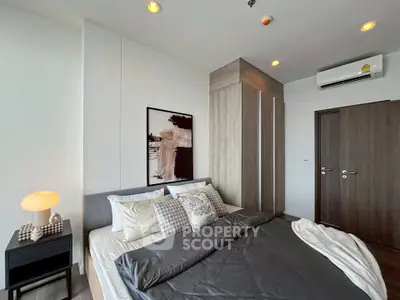 Modern bedroom with stylish decor and cozy ambiance, featuring a comfortable bed and elegant lighting.
