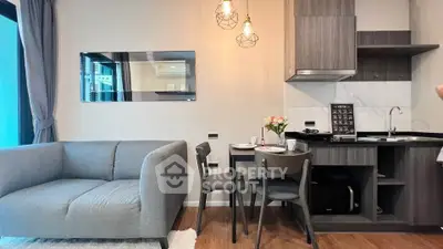 Modern living room with stylish kitchen and cozy seating area
