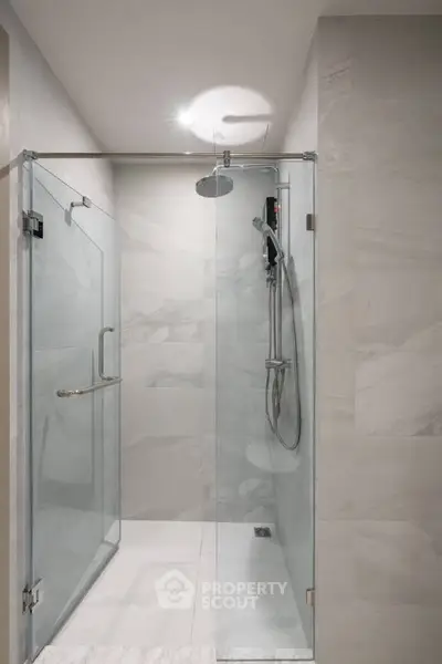 Modern bathroom with glass shower enclosure and sleek fixtures