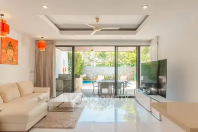 Luxurious living room with pool view, modern decor, and spacious layout for ultimate comfort.
