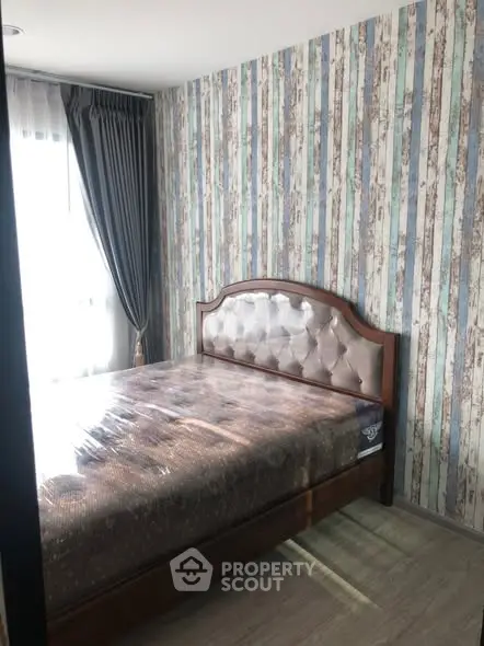 Cozy bedroom with stylish wallpaper and elegant bed frame, perfect for relaxation.