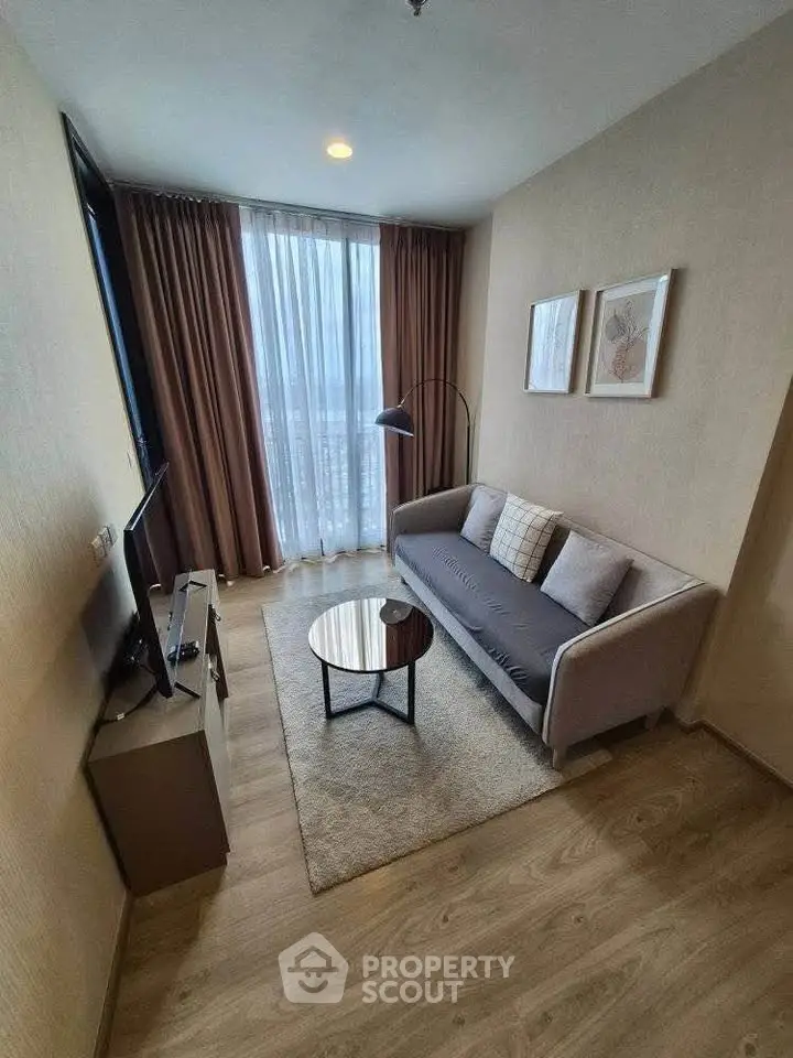 Cozy modern living room with stylish decor and large window view