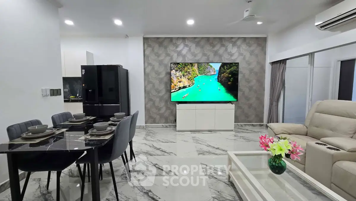 Luxurious modern living room with marble flooring, elegant dining area, and large TV for ultimate comfort.