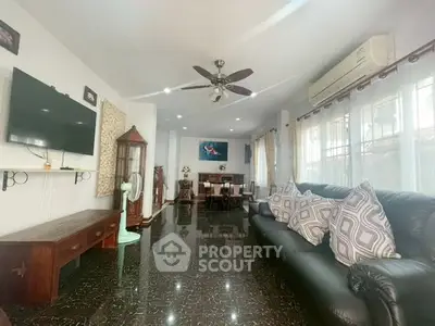 Spacious living room with elegant decor and ample natural light