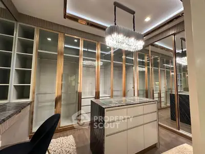 Luxurious walk-in closet with elegant lighting and ample storage space