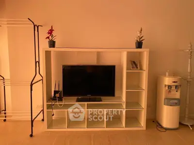 Modern living room with sleek TV stand, elegant decor, and water dispenser, perfect for contemporary living.