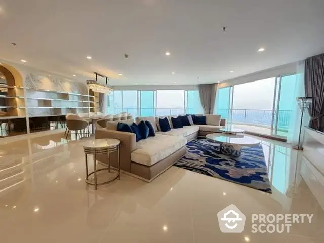 Luxurious open-plan living space with gleaming marble floors, expansive ocean views, and elegant furnishings, perfect for high-end lifestyles.