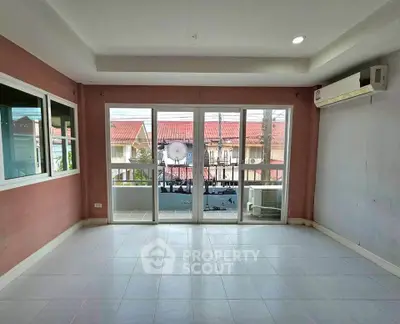 Spacious living room with large windows and balcony access in modern home