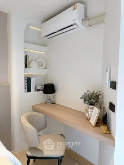 Cozy study nook with built-in desk and modern decor in a bright room.