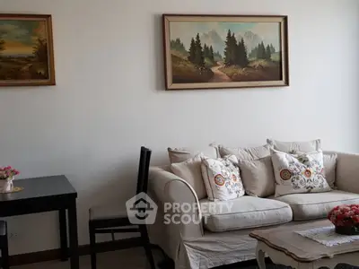 Charming living room with cozy sofa and elegant wall art in a serene setting.