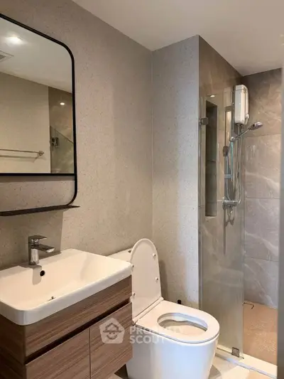 Modern bathroom with sleek fixtures and glass shower enclosure