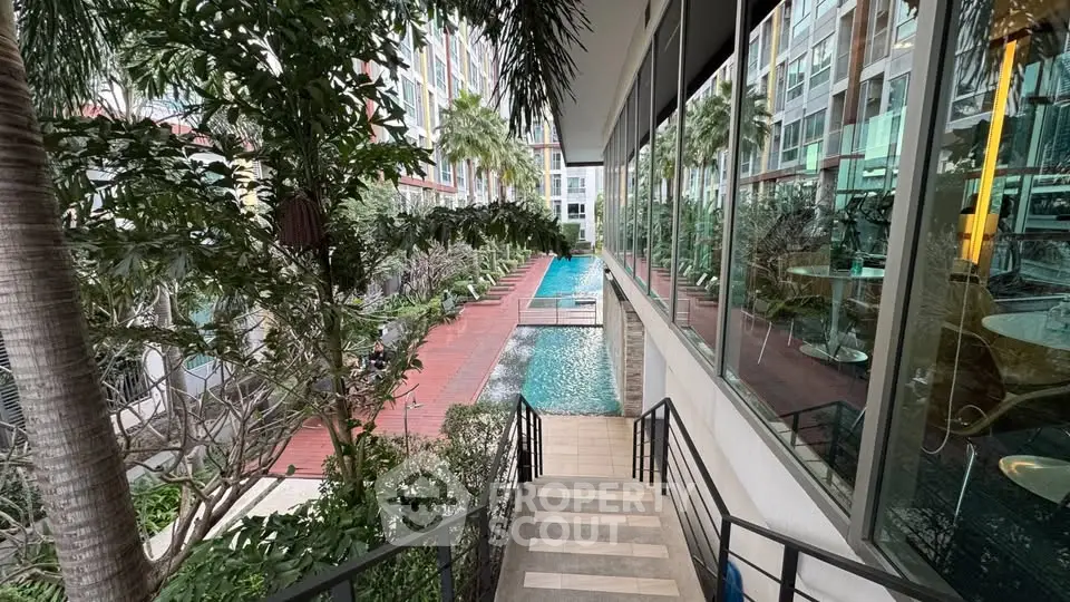 Luxurious condominium with lush garden and inviting pool view