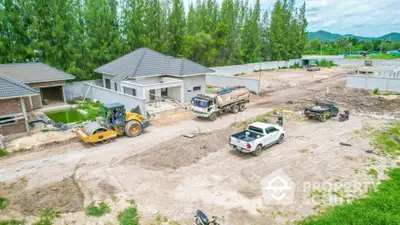 New residential construction site with modern houses and construction vehicles