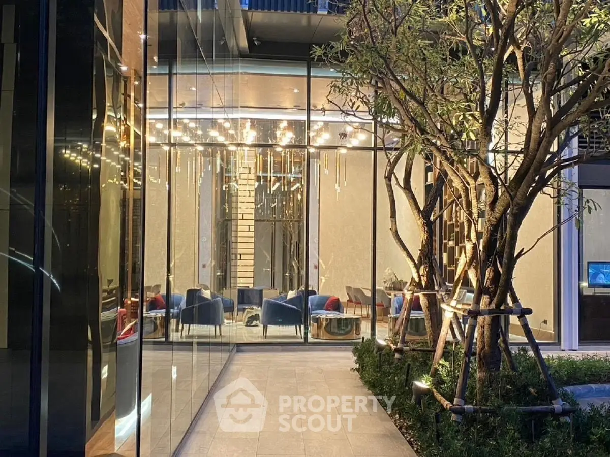 Luxurious building entrance with modern glass facade and elegant lighting