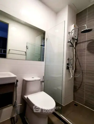 Modern bathroom with glass shower enclosure and sleek fixtures