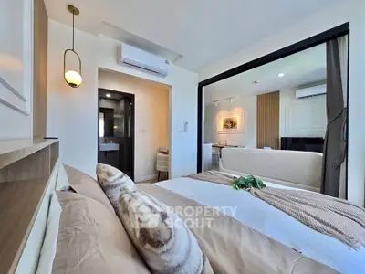 Modern bedroom with stylish decor and open layout to living area