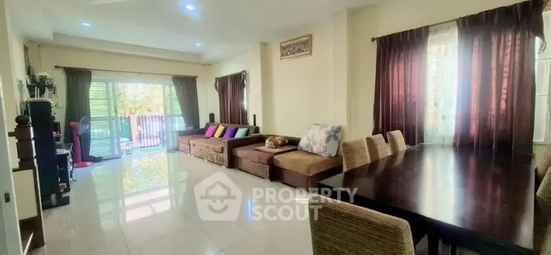 Spacious living room with modern decor and large windows for natural light.