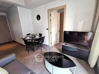 Modern living room with sleek furniture and dining area, perfect for urban living.