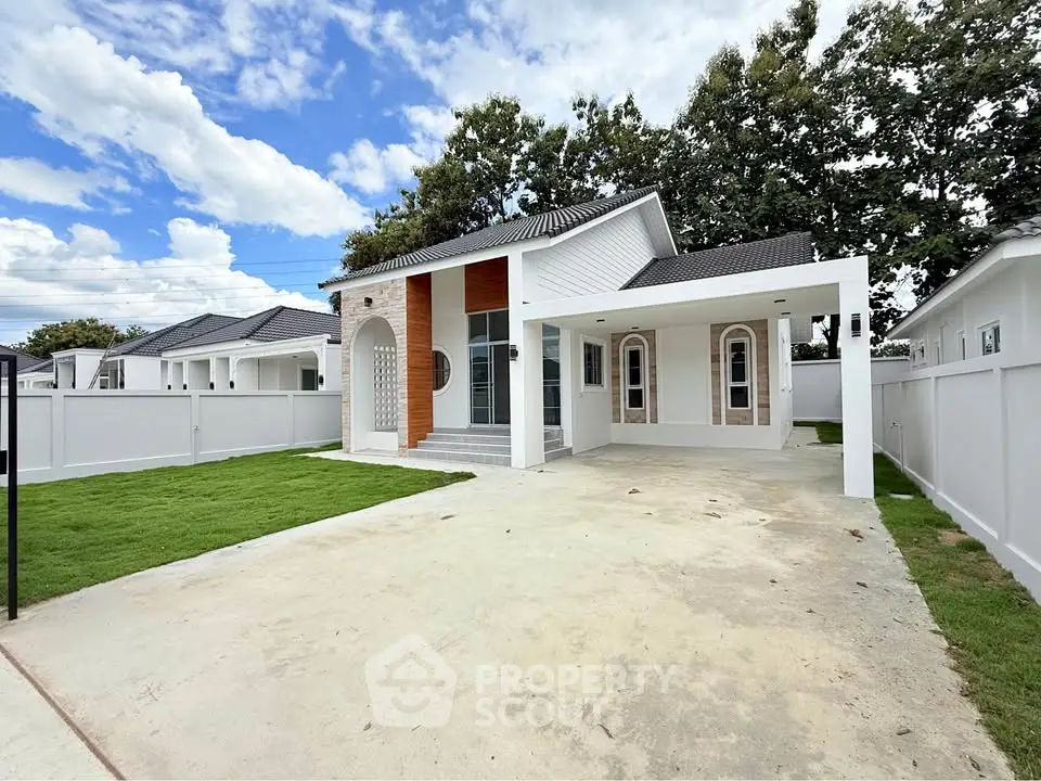Charming modern house with spacious driveway and lush green lawn, perfect for family living.