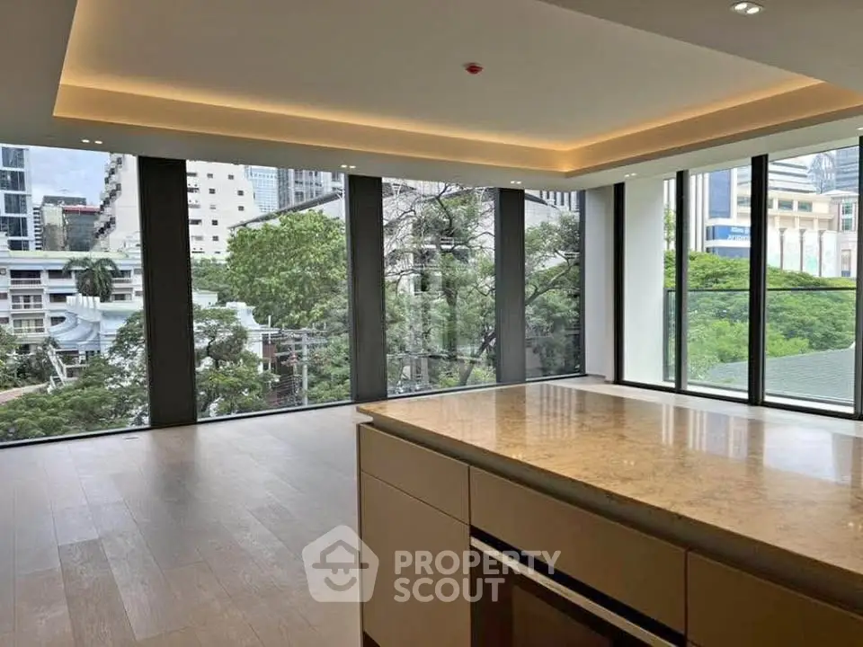 Spacious modern living room with floor-to-ceiling windows and city view
