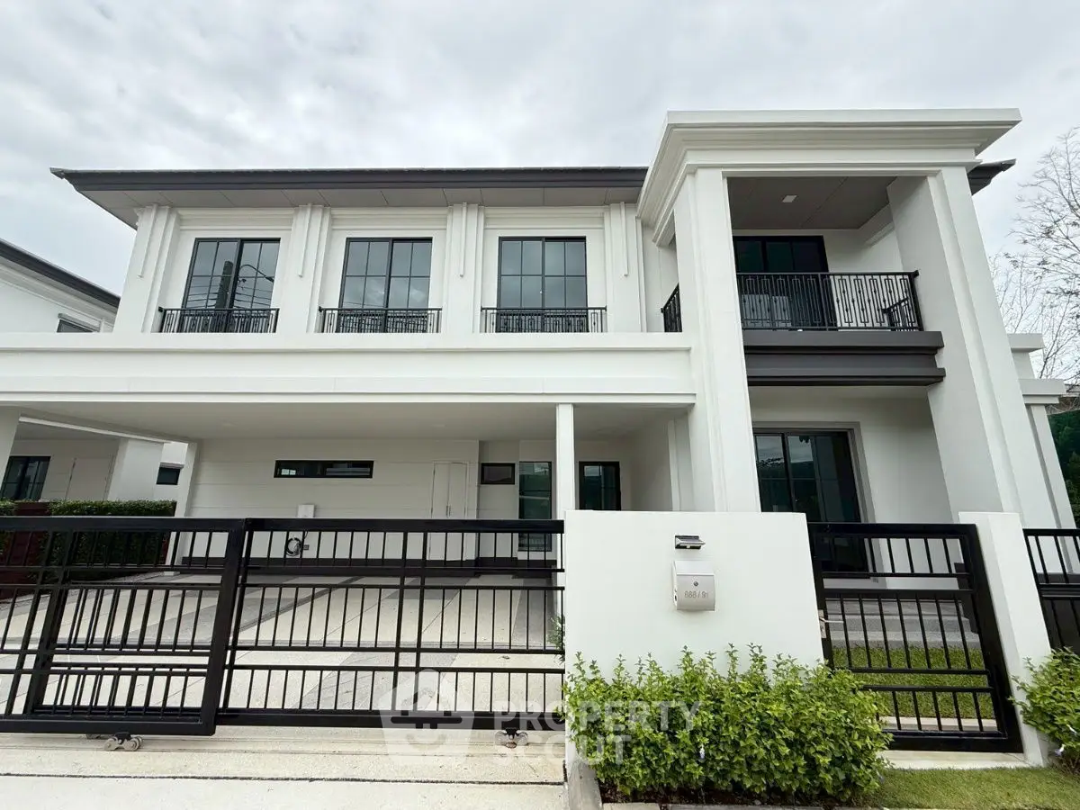 Elegant modern two-story house with sleek black gate and spacious driveway