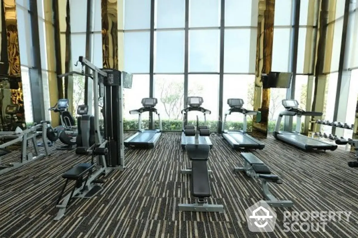 Luxurious high-rise gym with modern equipment and floor-to-ceiling windows