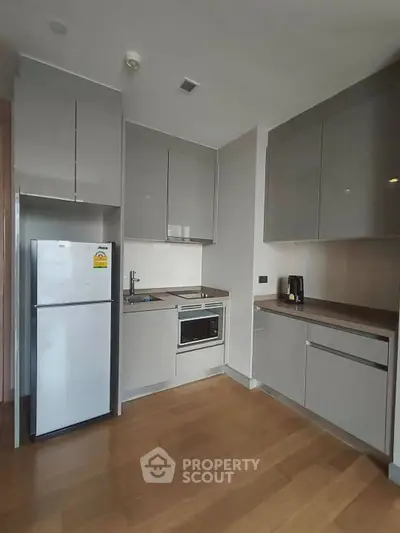 Modern kitchen with sleek cabinetry and built-in appliances in a stylish apartment.