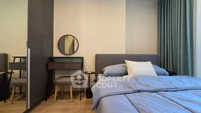 Modern bedroom with stylish decor and cozy bedding in a contemporary apartment.