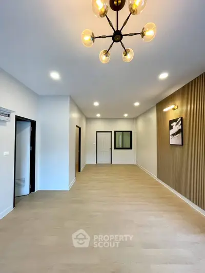 Spacious modern living room with elegant lighting and wood accents