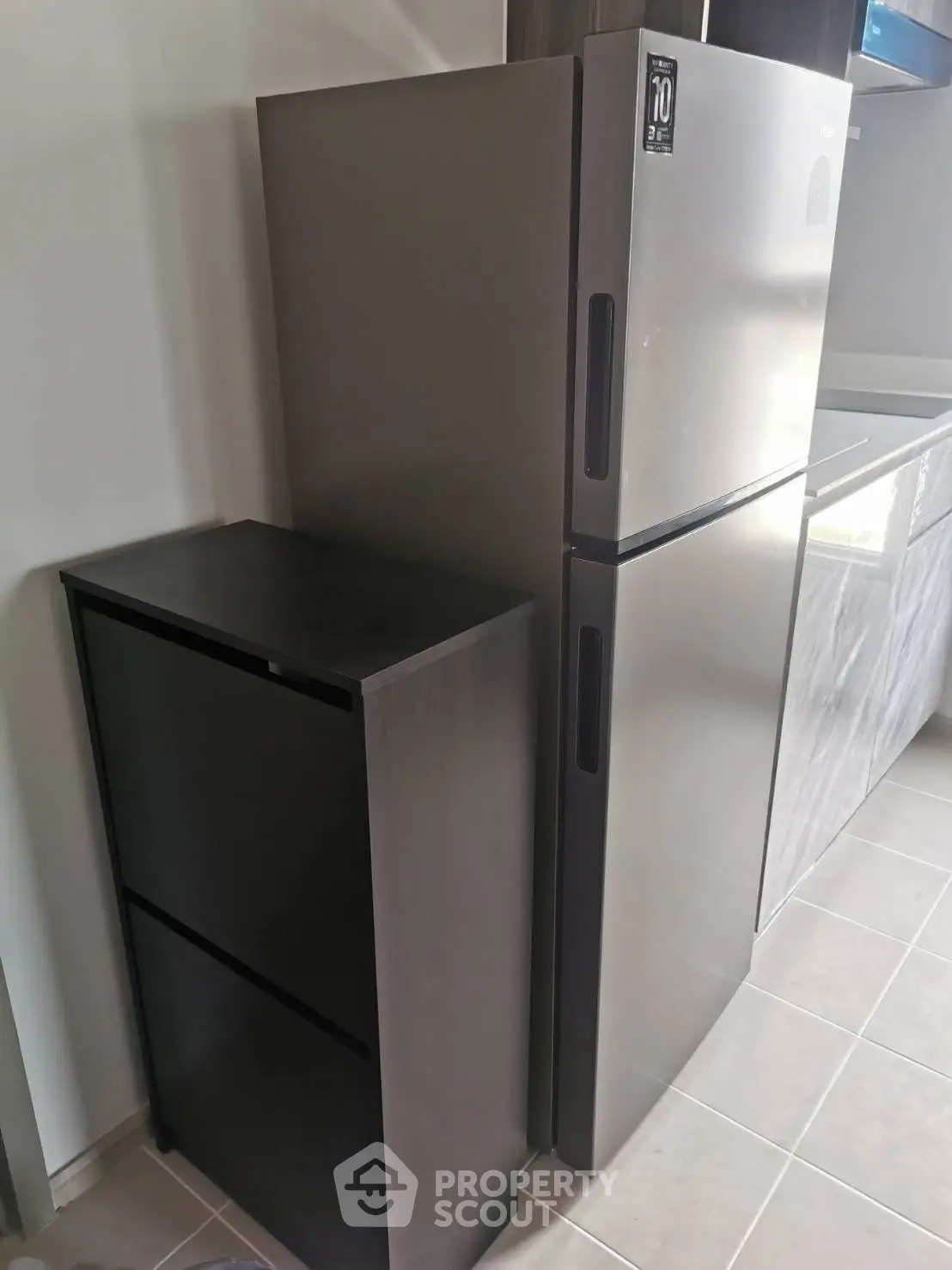Modern kitchen with sleek refrigerator and storage unit, perfect for contemporary living.