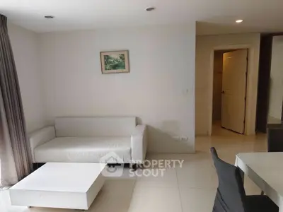 Modern living room with white sofa and minimalist decor in a bright apartment.