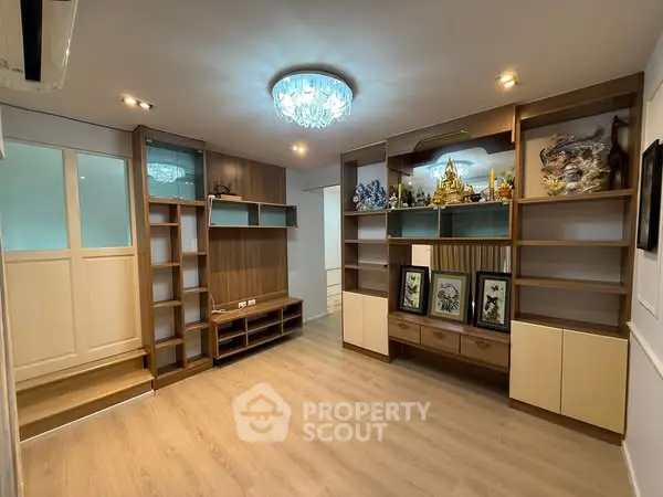 Spacious living room with elegant built-in shelves and modern lighting
