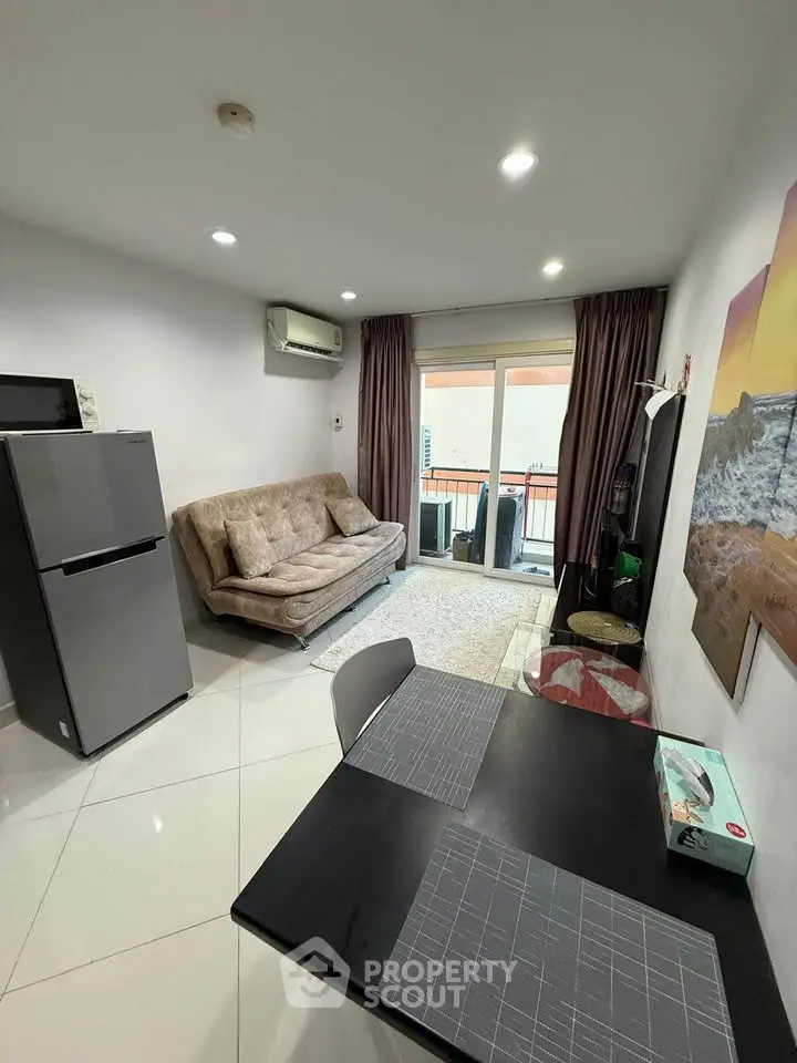 Modern living room with sleek furniture and balcony access