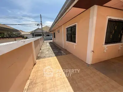 Charming single-story home with tiled walkway and secure windows in a peaceful neighborhood.