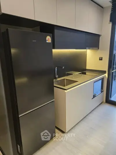 Modern kitchen with sleek cabinetry and built-in appliances