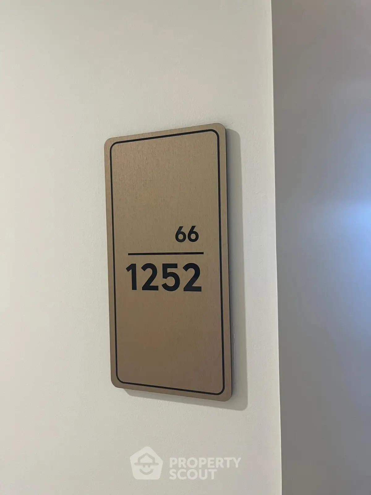Modern apartment door number 1252 on a sleek wall plaque.