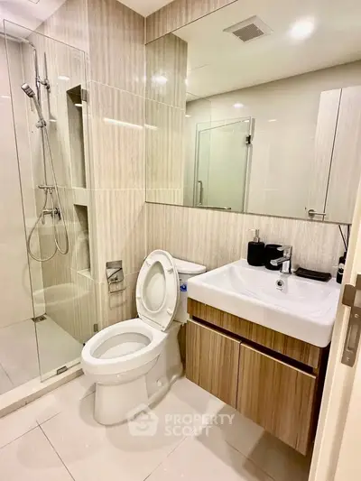 Modern bathroom with glass shower and sleek wooden cabinetry