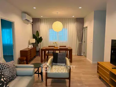 Stylish modern living room with elegant dining area and cozy seating arrangement.