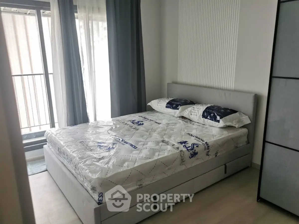 Modern bedroom with natural light and stylish decor in a contemporary apartment.