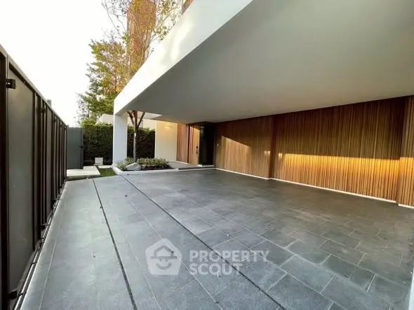 Modern luxury home entrance with sleek design and spacious driveway