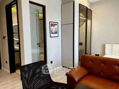 Modern living room with stylish furniture and sleek design, featuring a cozy leather sofa and contemporary decor.