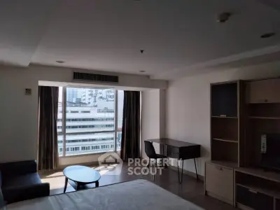 Spacious bedroom with city view and modern furniture, ideal for urban living.