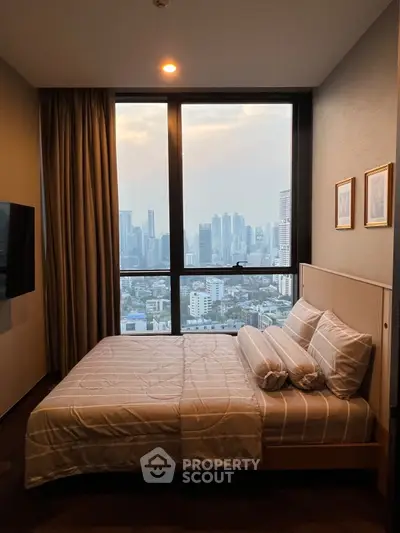 Luxurious bedroom with stunning city skyline view from large window.