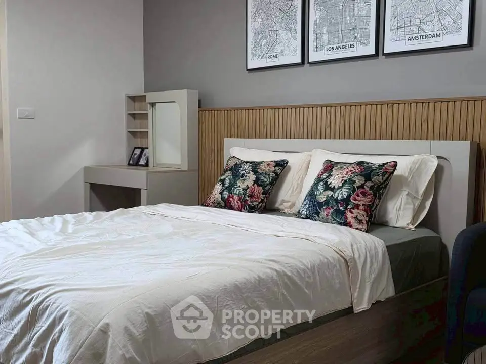 Cozy bedroom with stylish decor and floral pillows, perfect for relaxation and comfort.